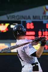 Cadet portrait after swinging bat with scoreboard in the background