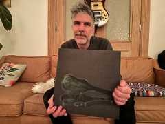 Hayden holding Are We Good album jacket