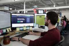 Professional man focused on computer work at modern office desk setup