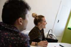 Smiling professional woman with hair in bun during business meeting
