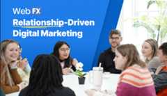 A group of people sit around a table and converse next to the words relationship-driven digital marketing.