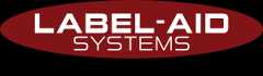 Logo of Label-Aid Systems featuring an oval shape with the company name in white letters and the tagline 'CUSTOM LABEL & GRAPHIC OVERLAYS' below it.