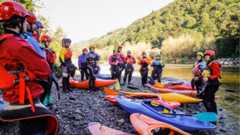 Photograph of a group of kayakers prepared to kayak