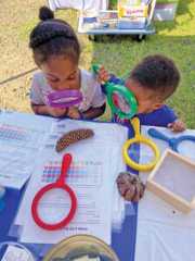 Children using large colorful magnifying glasses