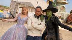 Caption L to R: Ariana Grande (as Glinda), Director Jon M. Chu, and Cynthia Erivo (as Elphaba), on the set of WICKED FOR GOOD, directed by Jon M. Chu.