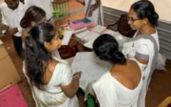 Staff members of the polling station check the lists of attendance