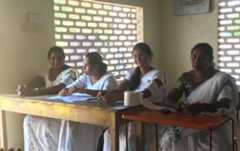Staff members of the polling station sitting behind their desks