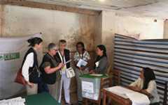Eu observers talking to the local staff of the polling station