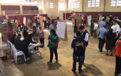 The inside of a large hall used as a polling station in El Salvador