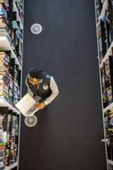 Woman reading a book in a library October 2022