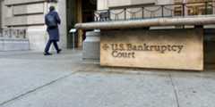 Exterior of gray stone building with brass etched sign that says US Bankruptcy Court