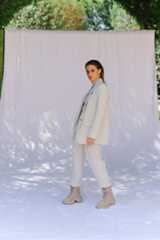 Image may contain Coat Clothing Apparel Human Person Sleeve Overcoat Outdoors Long Sleeve and Female