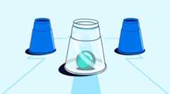 Three cups are arranged in a row with a teal ball visible under the transparent center cup.