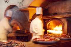 Image may contain Fireplace Indoors Human Person Hearth Food and Pizza