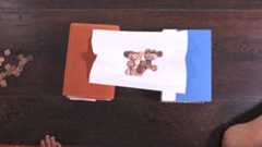 A paper bridge holding up pennies