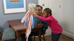 A mother and daughter make a windsock