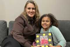 A mom and daughter with a family album