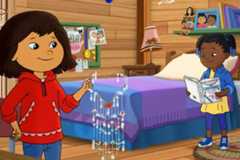 Molly holds up her beaded suncatcher