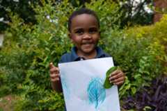 A boy with his leaf and bark rubbing paper