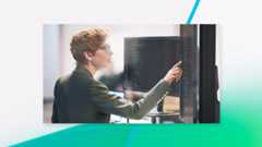 Person looking and pointing at a monitor.