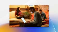 Male developer working remotely from a cafe.