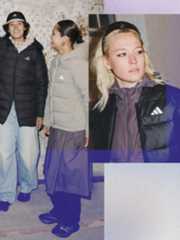 The image shows two young individuals wearing winter coats and hats, standing in what appears to be a snowy outdoor setting. In the foreground, a woman with blonde hair is also wearing a winter coat and appears to be looking directly at the camera.