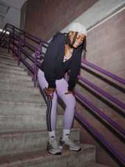 Desi Luila wearing the Optimé Leggings coming down a flight of stairs
