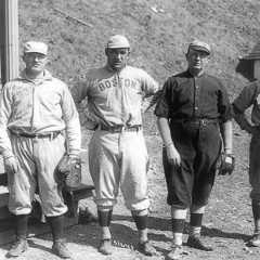 Group of white men in "Boston" baseball uniforms standing in line