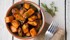 oven roasted sweet potatoes with thyme and rosemary in a bowl oven roasted sweet potatoes with thyme and rosemary in a bowl