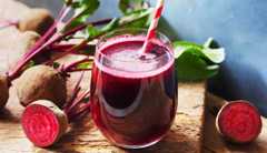 Glass of beet juice surrounded by beets. Glass of beet juice surrounded by beets.
