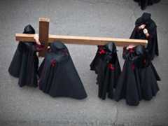 Holy week. Easter. Valladolid. Procession of Nazarenos carry a cross during the Semana Santa (Holy week before Easter) in Valladolid, Spain. Good Friday