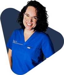 Elizabeth russ ocean Liz, a smiling woman in blue medical scrubs with glasses.