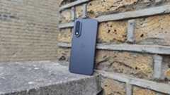The OnePlus Nord 5 against a brick wall.