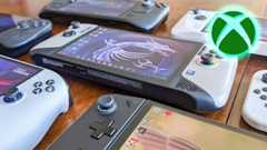 Several Windows handheld gaming PCs laying down on a table. An Xbox logo is in the upper right corner of the image.