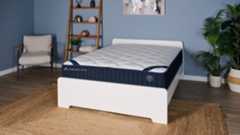 The DreamCloud Classic Hybrid Mattress in a blue bedroom.