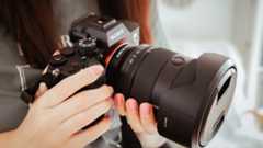 Photographer holds one of the best cameras for photos and videos in their hands