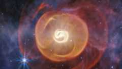 A swirling blob of white light is surrounded by an orange bubble with purple and pink light around that