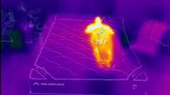 An image of a Tom's Guide tester lying on the DreamCloud Classic mattress through a thermal imagery camera. While the rest of the room and mattress are in shades of purple, indicating a cooler temperature, the tester is a bright orange color. A target over the 'hotspot' shows a temperature of 79.9F, which was the maximum temperature reached during the temperature regulation tests.