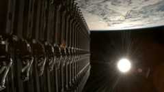 a stack of satellites are deployed into Earth orbit with the full sun visible