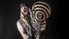 Zakk Wylde branding a guitar (studio portrait)