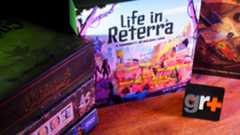 A stack of board games on a wooden table beside Life in Reterra and Gloomhaven: Jaws of the Lion, all behind a GamesRadar+ logo