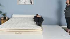 Tom's Guide mattress tester Lauren Jeffries performing an edge support test on the Saatva Classic. The Saatva's edge support is so sturdy that 2.5" of Lauren's body was off the side of the mattress and she still felt comfortable enough to sleep