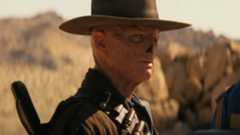 Walton Goggins as The Ghoul looking seriously at Lucy.