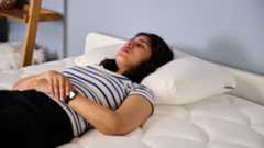 TG bedding writer sleeping on the Purple GridCloud Pillow while testing it in TG Sleep Studio