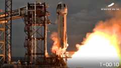 A white Blue Origin New Shepard rocket lifts off with 6 passengers aboard.