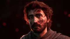 Best Expedition 33 attributes: A close-up shot of Gustave with a haunted facial expression, covered in dirt.