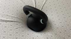 A 50lb weight resting oin the Zinus Green tea Memory Foam Mattress, showing noticable sink