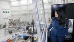 a person looking over a clean room that has spacecraft in it