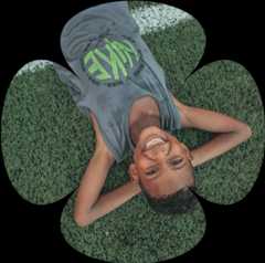 Niño acostado en el pasto footer Fundación Pies Descalzos