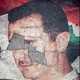 A defaced poster of Bashar al-Assad